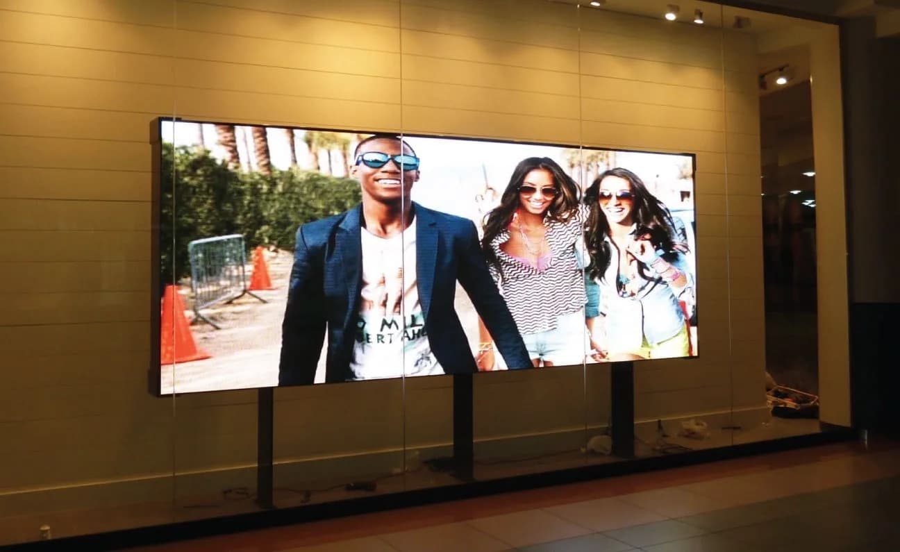 Wide LED screen in a showroom showing a fashion photo