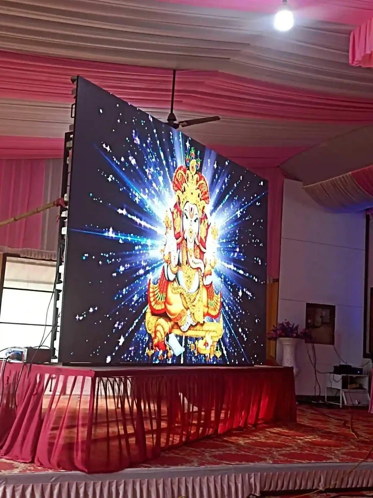 LED screen on a decorated stage with a red skirt